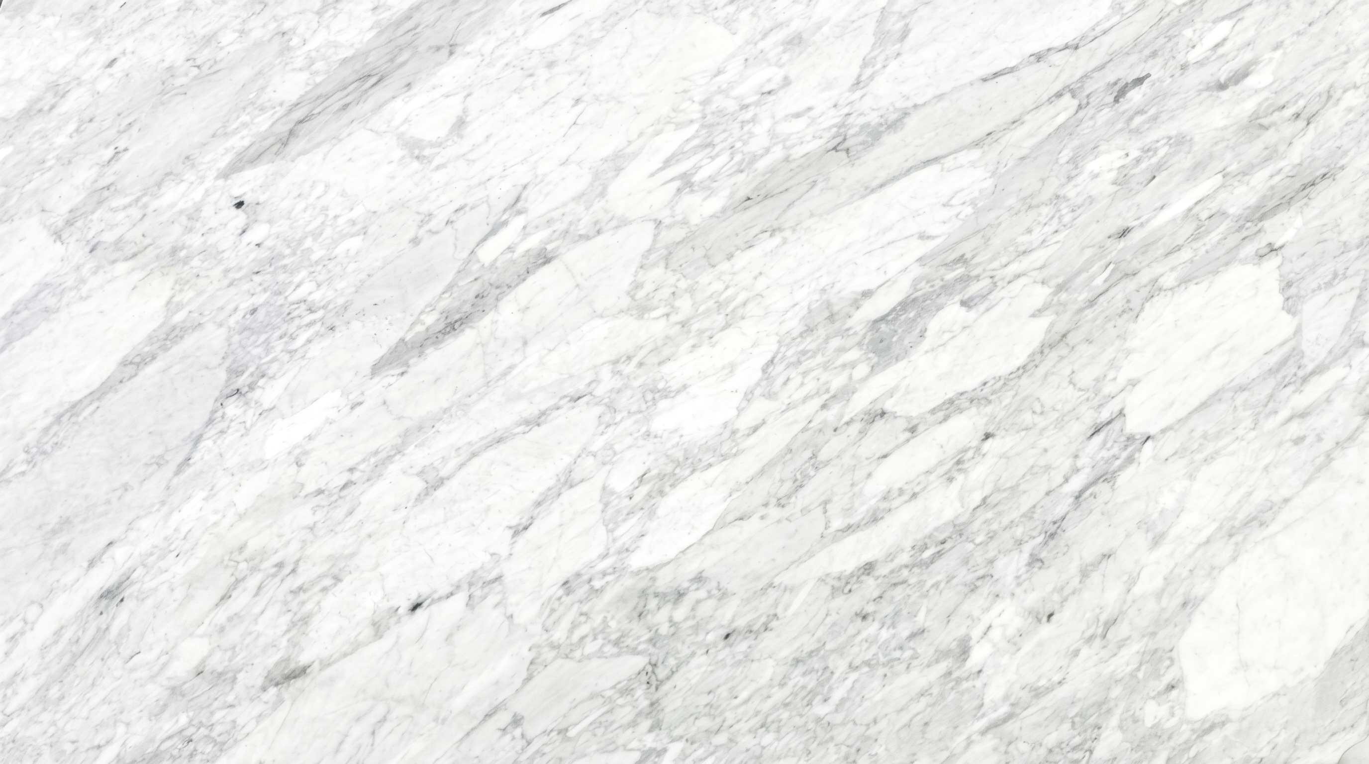 Premium Carrara White Imported Marble featuring soft feathery grey veining on a brilliantly translucent white base. High-quality polished slab supplied wholesale in Kishangarh.