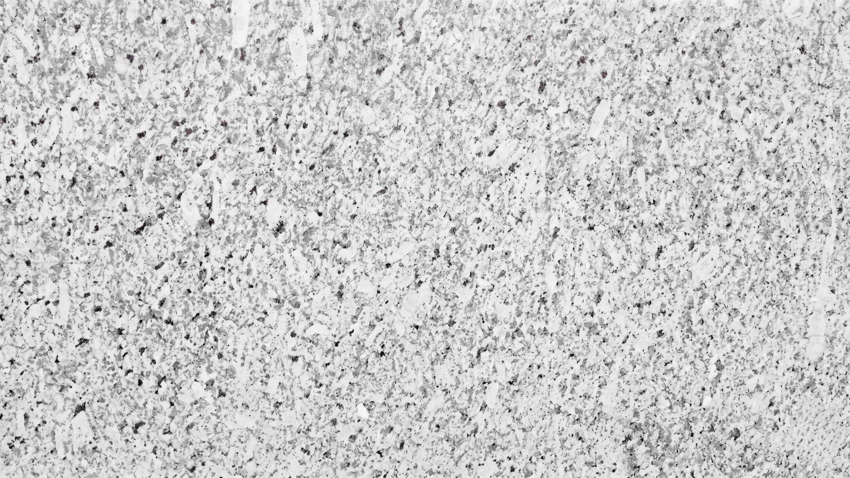 Premium Moon White Indian Granite featuring a brilliant white canvas accented with subtle silver and ivory swirls. High-quality polished slab supplied wholesale in Kishangarh.