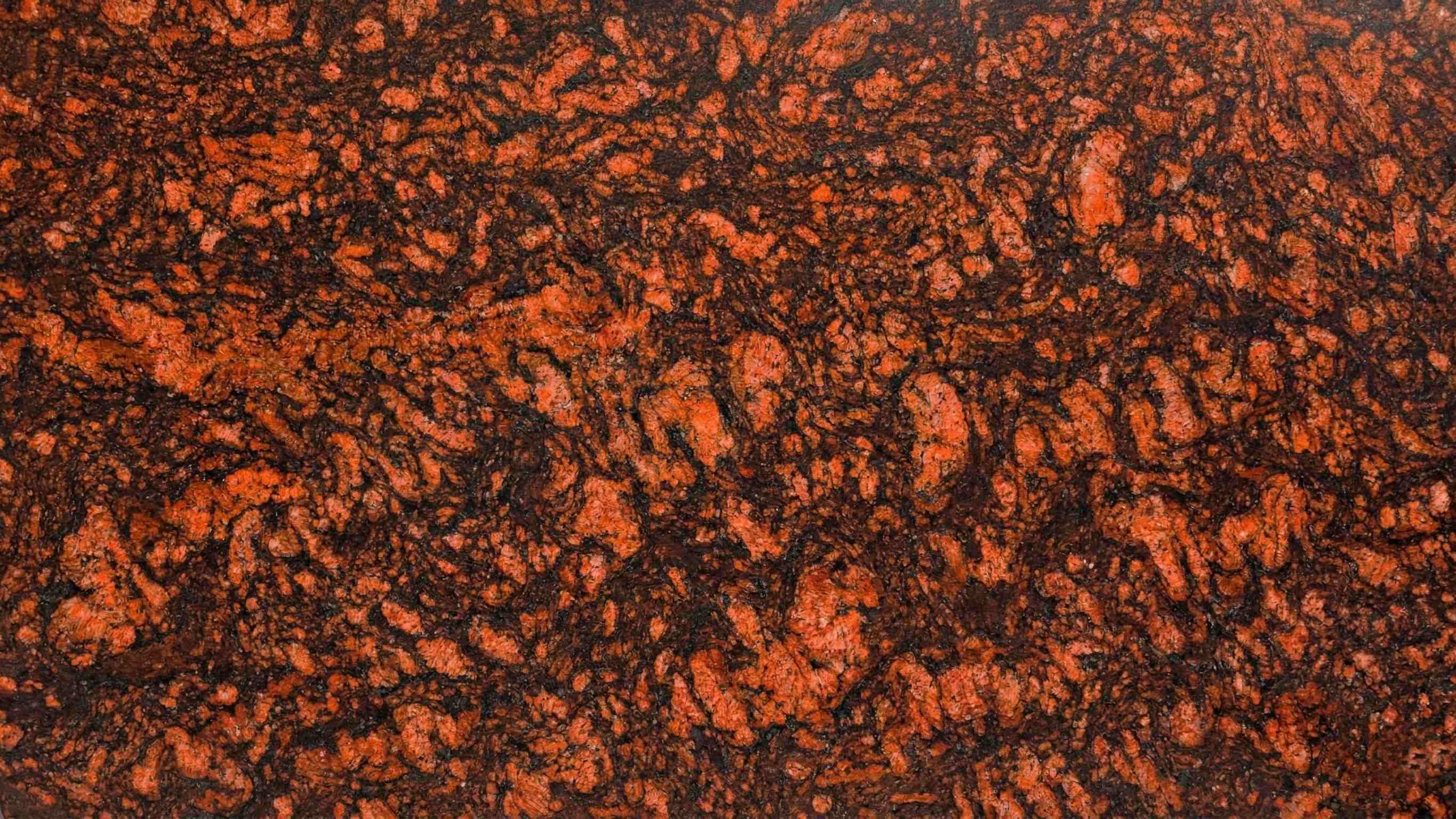 Premium O Red Indian Granite featuring a bold, vibrant, and passionate red canvas. High-quality polished slab supplied wholesale in Kishangarh.