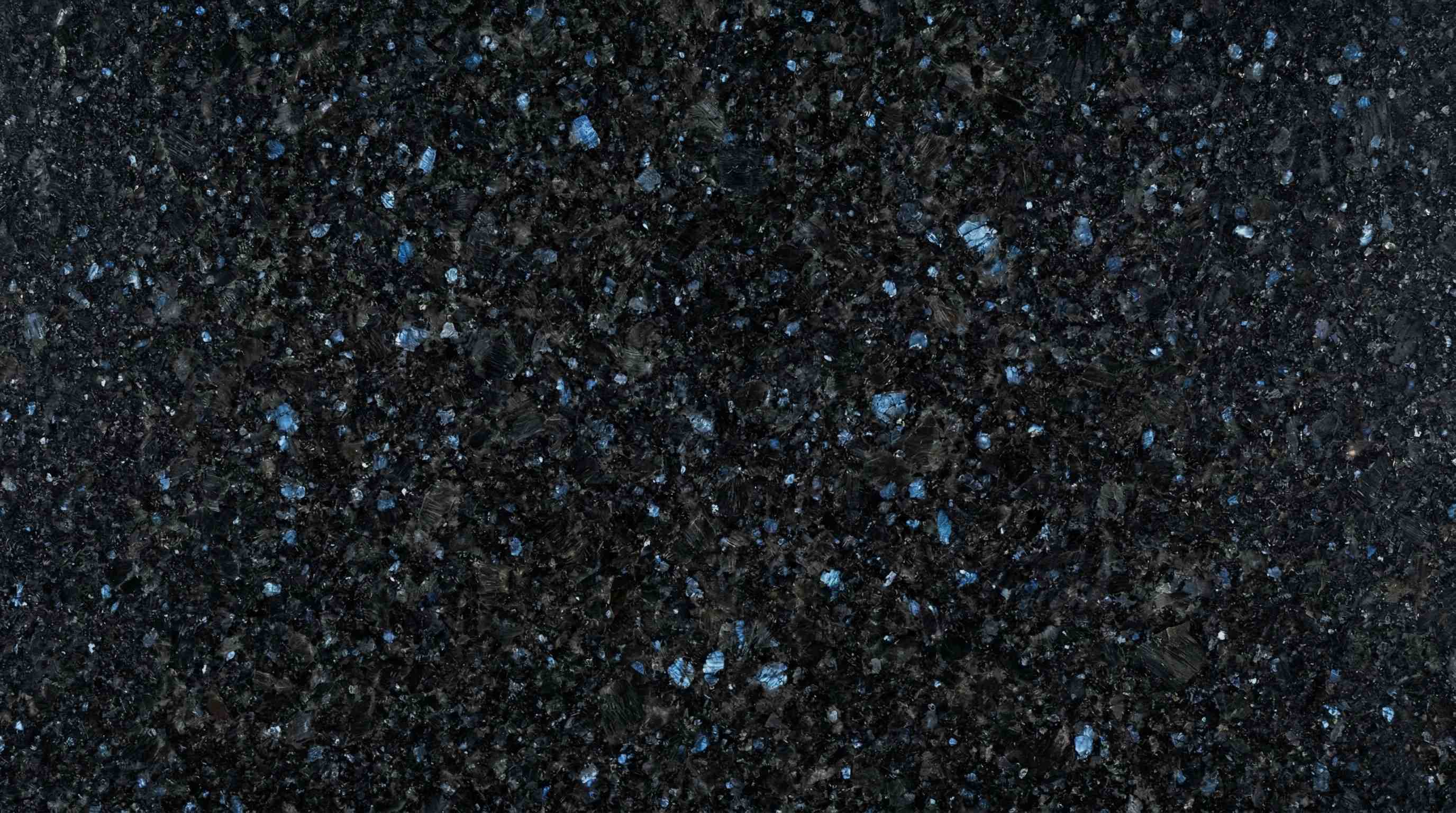 Premium Rajasthan Black Blue Crystal Indian Granite featuring a spectacular fusion of midnight black and vibrant azure crystals. High-quality polished slab supplied wholesale in Kishangarh.