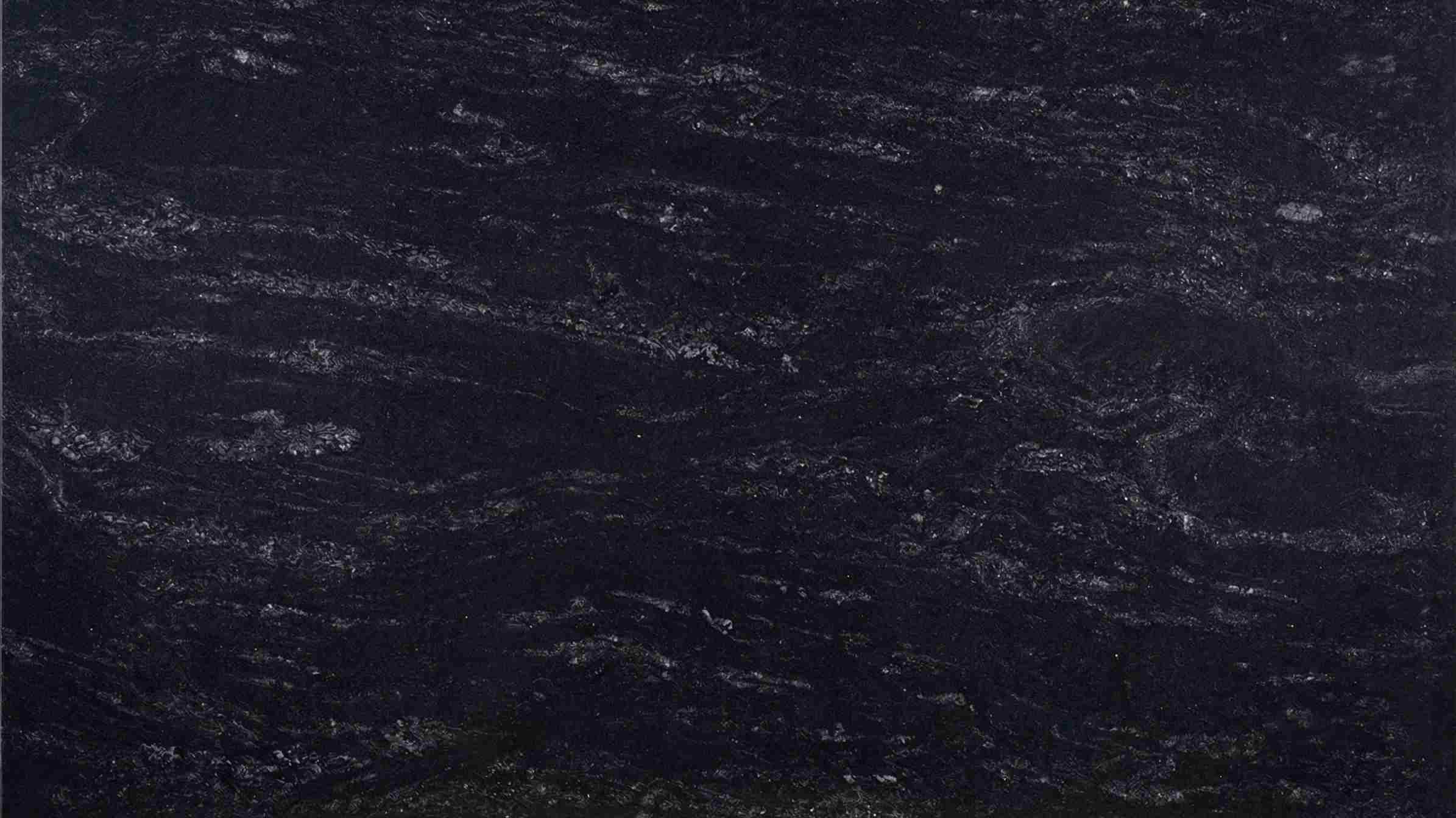 Premium River Black Indian Granite featuring flowing rivers of white quartz rushing through a dark dramatic background. High-quality polished slab supplied wholesale in Kishangarh.