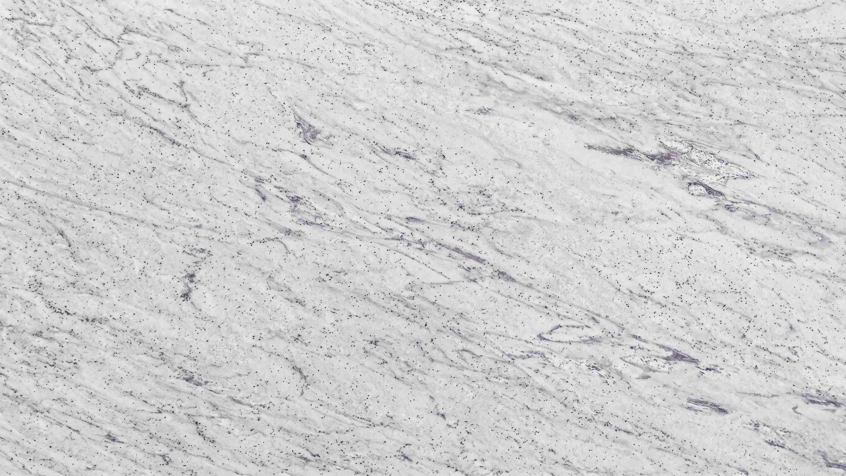 Premium River White Indian Granite featuring soft, sweeping waves of gray and burgundy flowing across a crisp white canvas. High-quality polished slab supplied wholesale in Kishangarh.