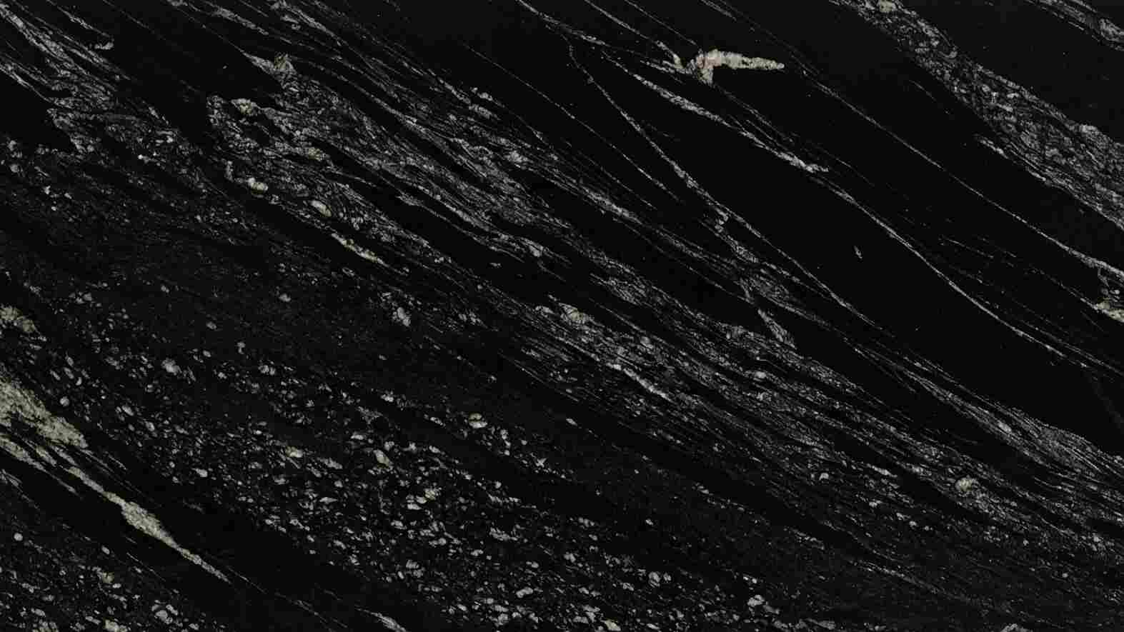 Premium Titanium Black Indian Granite featuring an industrial blend of silver, gold, and deep black swirls. High-quality polished slab supplied wholesale in Kishangarh.